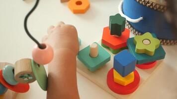 Engaging toddler playing with colorful shape sorting toys video