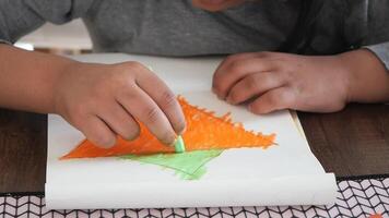 Child creating colorful art using chalk on a table video