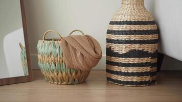 Decorative woven baskets and vase in a cozy room video