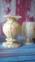 Decorative vases and chalices displayed on a colorful wooden table video