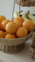 Fresh oranges and bananas in woven baskets on a table video