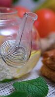 mint lemon tea with cherry Rotating view of spiced hot lemon tea in a stylish glass cup with yellow handle video