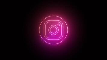 Pink glowing neon Instagram icon, neon frame on black background, Instagram neon lines, abstract background with animation of the saber in the abstract futuristic loop with neon light. video
