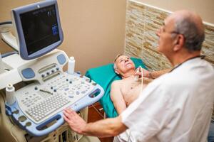 Man with heart problems is having exam at clinic photo