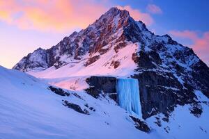 A breathtaking mountain scene featuring a majestic peak, cascading ice waterfall, and vibrant sunset colors illuminating the snow-covered landscape. photo