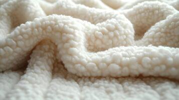 Soft white textured fabric draping elegantly across a cozy surface in a warmly lit room photo