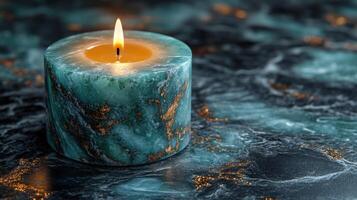 Unique green marble candle glowing on dark marble surface in a serene setting at dusk photo