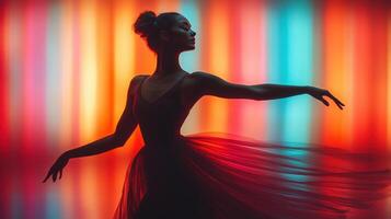 Dancer performs gracefully against vibrant colored backdrop during a contemporary art event at dusk photo