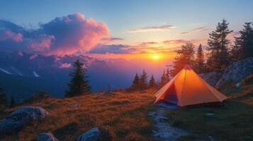 Sunset camping in the mountains with a glowing tent and vibrant sky view photo