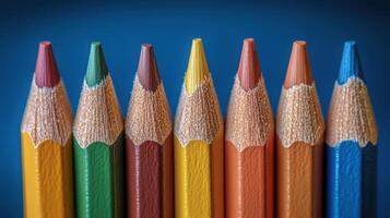 Colored pencils arranged in a row ready for artistic projects or creative activities indoors photo