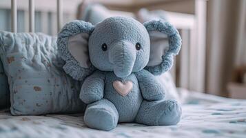 Soft blue elephant plush toy sits on a bed in a cozy bedroom decorated with pastel colors and soft pillows photo