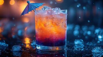 Colorful cocktail with decorative umbrella and ice in a dimly lit bar setting photo