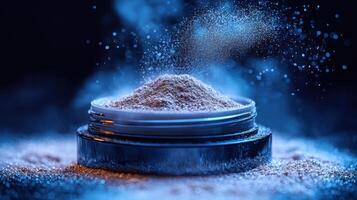 Shimmering powder container surrounded by a cloud of dust in a cool blue atmosphere photo