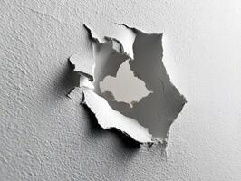 A textured wall with a large, jagged hole in the center, revealing another rough surface beyond it. The torn edges of the wall show layers of material breaking apart photo