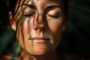 Sunlight casts intricate patterns on a serene face with closed eyes, revealing freckles and a peaceful expression, highlighting natural beauty and tranquility in a close-up portrait photo