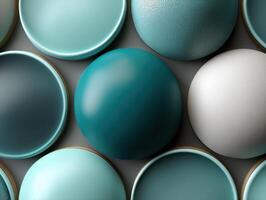 Circular objects in shades of teal and white are arranged in a grid pattern. Smooth and textured surfaces create a visually appealing composition emphasizing contrast photo