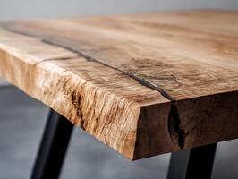 Natural wood table with visible grain and live edge design, showcasing textured surface and a sturdy metal leg underneath, capturing a rustic, artisanal aesthetic photo