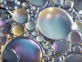 Colorful abstract pattern of variously sized spheres with a glossy, reflective surface. The spheres feature soft gradients of blues, purples, and golds, creating a mesmerizing effect photo