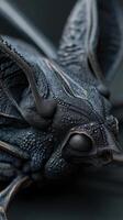 Intricate close-up of a textured, metallic-blue insect head, with detailed eyes and antennae. The shot highlights the unique tactile surface patterns and structures photo