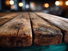 Weathered wooden surface with visible grains and metal nails, set against blurred warm lights in the background creating a cozy atmosphere. No text is present in the image photo