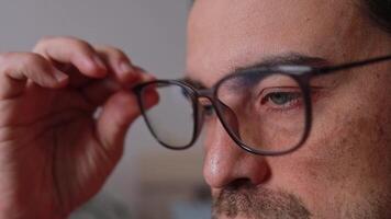 Close up of a man's eyes wearing glasses, rubbing his eyes from discomfort and dryness. Eye diseases video