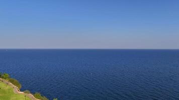 Rotating Aerial View of Cliffs, Turquoise Sea, and Park video