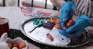 Enjoying Easter eggs while coloring and decorating red Easter eggs for a festive celebration photo