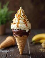 Banana Ice Cream in Chocolate-Dipped Cone with Banana Slices and Caramel photo