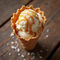 Caramel Ice Cream Cone with Caramel Drizzle and Sea Salt on Rustic Wooden Table photo