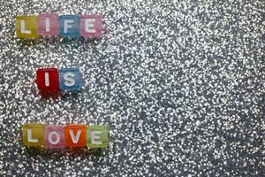Colorful letters spell out meaningful words on a sparkling background for a creative artistic display photo
