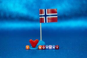 Creative display of a Norwegian flag and colorful letters conveying affection for Norway on a vibrant background photo