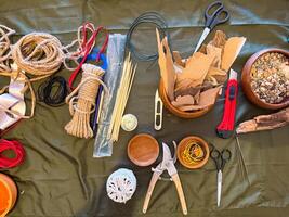 Tools and materials for creating ikebana art arranged on a work surface. Preparation, focus and the meditative process of floral design. Workshop concept photo