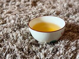 Quiet moment during a traditional tea ceremony with warm tea in a porcelain cup. Harmony, mindfulness and peaceful ritual practice photo