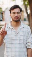 Upset Indian man reacting to unpleasant idea, dissatisfied with bad quality, wave finger on street video