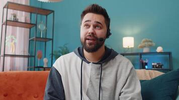 Young man freelance worker call center or support service operator helpline having talk with client video