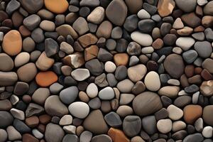 Close up of a rock wall with many different colored rocks. The rocks are of various sizes and shapes photo