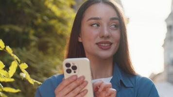 Young woman using smartphone typing text messages looking for a way on map in mobile navigator app video