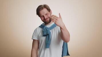 Man showing inviting gesture with hands, ask to join, beckoning to coming, gesturing hello goodbye video