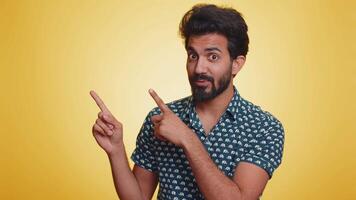 Bearded indian man looking at camera doing phone gesture like says hey you call me back conversation video