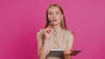 Woman making notes writing down thoughts with pen into notepad notebook diary, to do list, good idea video