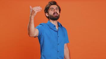 Man showing inviting gesture with hands, ask to join, beckoning to coming, gesturing hello goodbye video