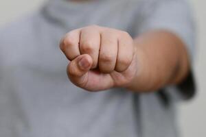 The child's hand is clenched into fist. photo