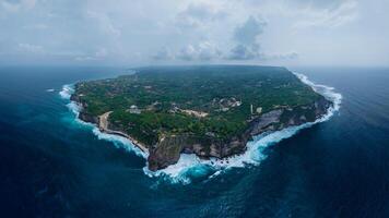 Panorama view of Uluwatu coastline with rocky cliffs, ocean with waves in Bali photo
