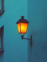 Warm street lamp illuminating building corner at dusk photo