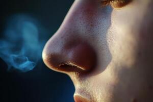 a close up of a person's nose with smoke coming out photo