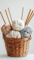 A basket filled with yarn and knitting needles photo