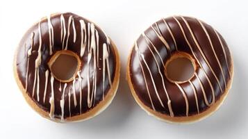 Two Chocolate Glazed Donuts with Drizzle Topping on White Background photo