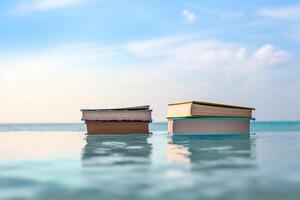 Three books sitting on the edge of a pool photo