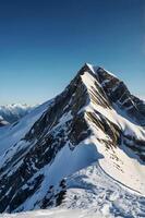 A person standing on top of a mountain with snow photo