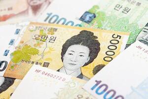 South Korean won money bills in big amount on white color table close up photo